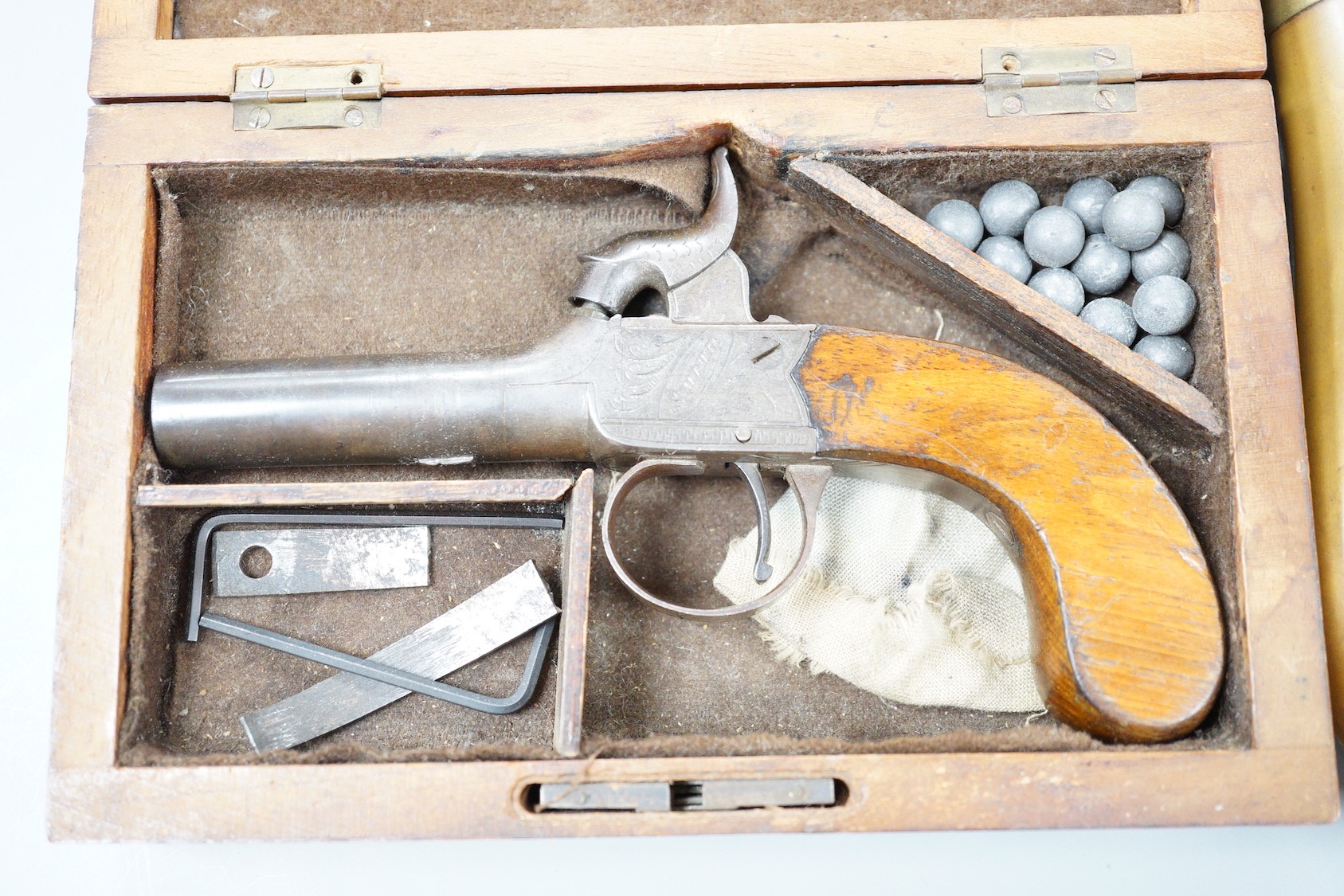 A cased early 19th century percussion pocket pistol by Smith, London and 2 shot flasks